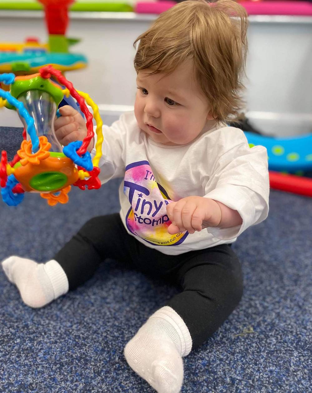 a toddler having fun at tiny stompers